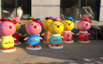 公園里街道邊擺放的五顏六色的玻璃鋼卡通雞雕塑